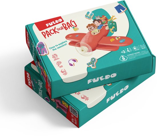 Doos van het spel "Pack Your Bag" met kinderen in een vliegtuig en kleding-icoontjes.
