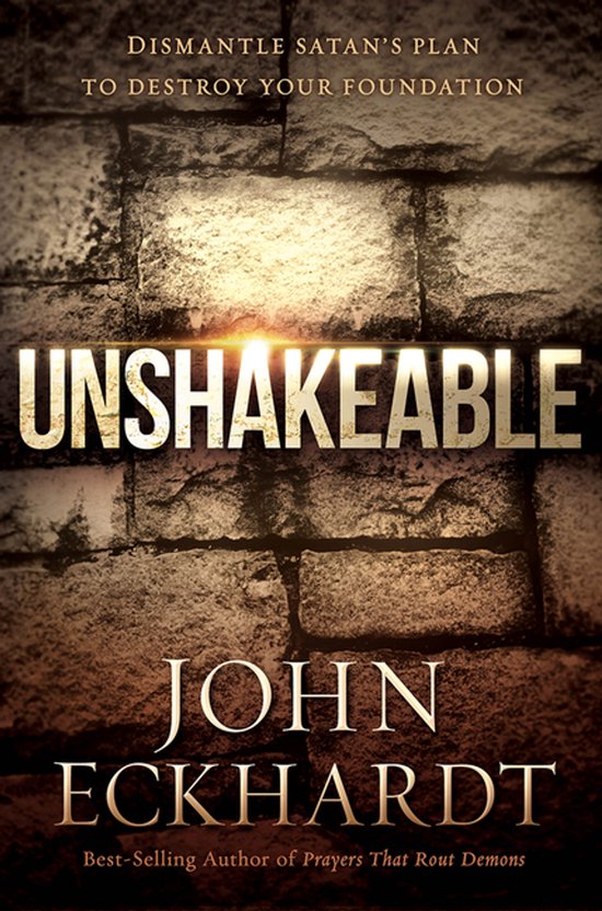 Couverture du livre 'Unshakeable' de John Eckhardt, avec un fond de mur de pierres et du texte doré.