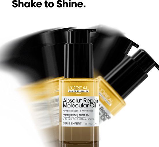 Flesje L'Oréal Absolut Repair Molecular Oil in beweging met vaag water.