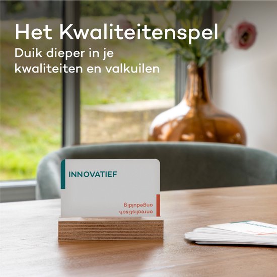 Kaart met "INNOVATIEF" op een houten standaard, met een vaas met bloemen op de achtergrond.