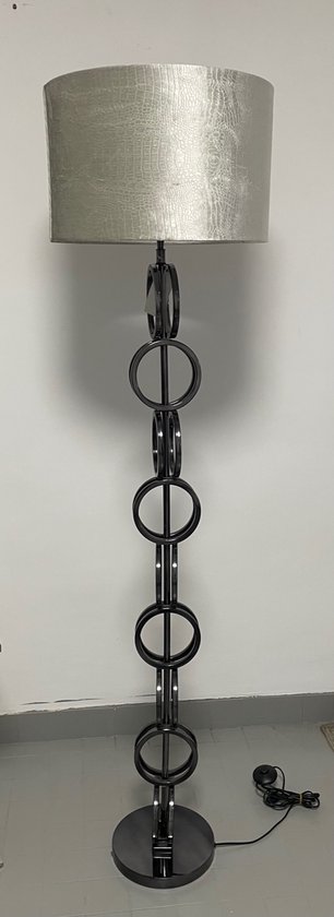 Grijze staande lamp met krokodillenleren kap, metalen frame met ringen.