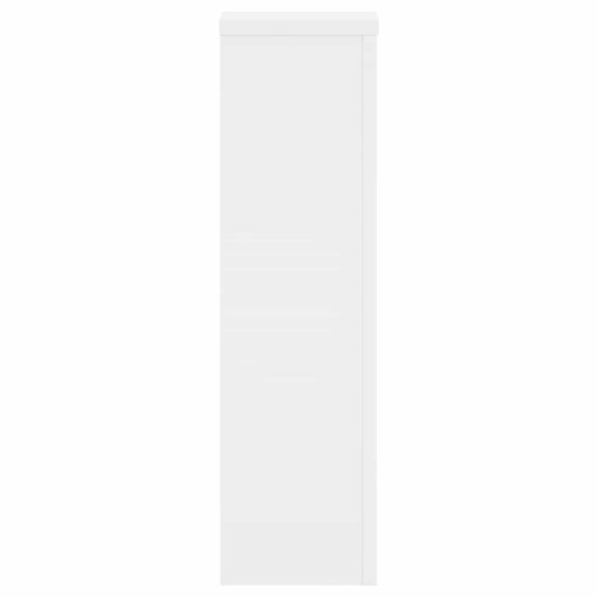 Zijaanzicht van een smalle, witte plantenstandaard.