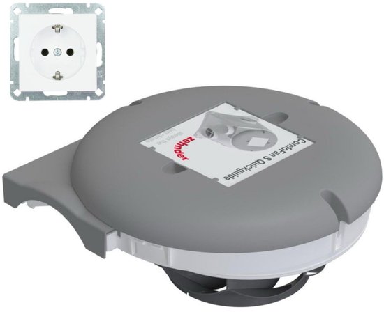 Grijze ventilator met handleiding 'ComfoFan S Quickguide' van Zehnder, naast een wit stopcontact.