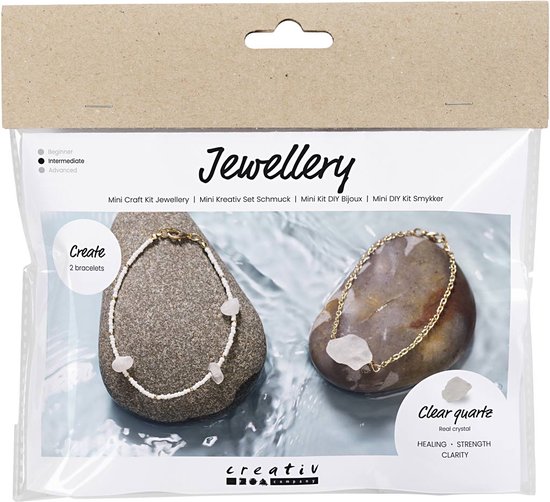Verpakking van een knutselset voor twee armbanden met bergkristal, met voorbeeldarmbanden op stenen.