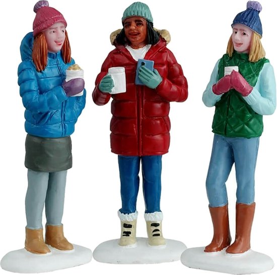 Drie poppetjes van vriendinnen in winterkleding die warme chocolademelk drinken.