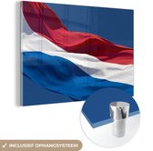 MuchoWow® Glasschilderij 90x60 cm - Schilderij acrylglas - Nederlandse vlag die in de wind wappert - Foto op glas - Schilderijen