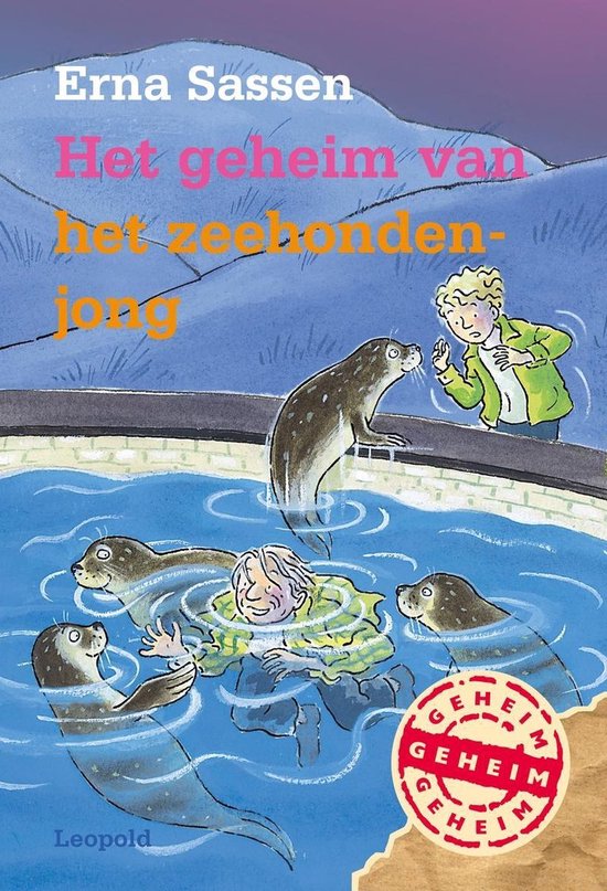 Boek 'Het geheim van het zeehondenjong' met een tekening van een jongen en zeehonden in water.