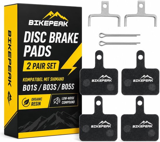 Set van 4 BikePeak organische schijfremblokken met metalen veren en splitpennen in een verpakking.