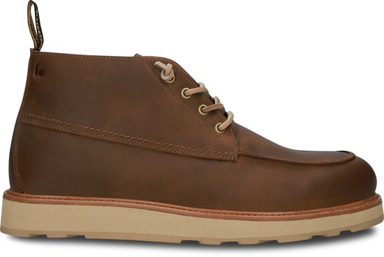 Zijaanzicht van een bruine Blackstone veterschoen met beige zool.