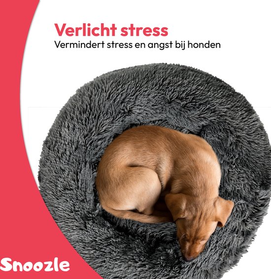 Bruine puppy slaapt in een ronde, donkergrijze, superzachte Snoozle mand. Verlicht stress.