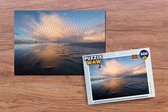 Puzzel Een zonsopgang over het water bij het eiland Schiermonnikoog - Legpuzzel - Puzzel 500 stukjes