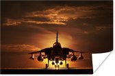 Poster Een silhouet van een straaljager tijdens een zonsondergang - 120x80 cm