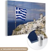 MuchoWow® Glasschilderij 120x80 cm - Schilderij acrylglas - Vlag Griekenland bij een dorp - Foto op glas - Schilderijen