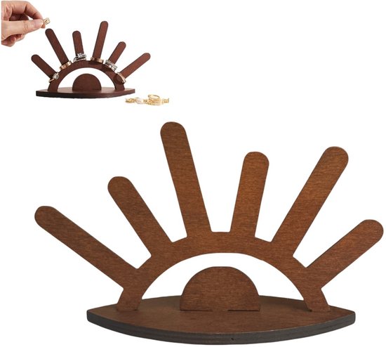 Donkerhouten ringenhouder in de vorm van een oog met wimpers, op een witte ondergrond. Er is ook een kleine afbeelding van een hand die een ring plaatst.