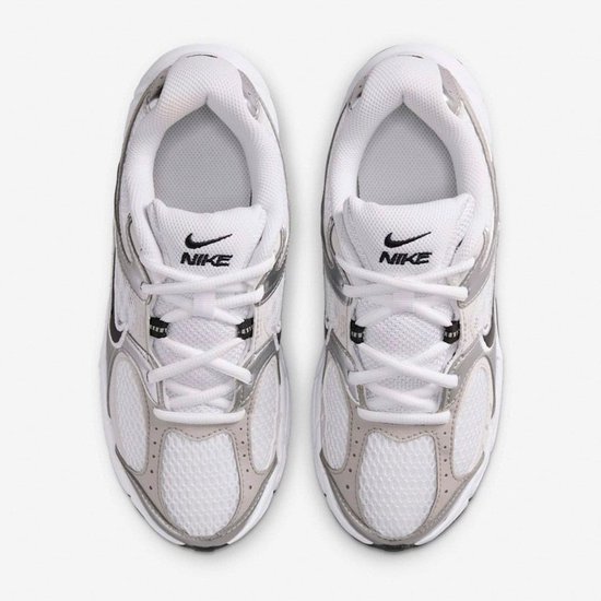 Bovenkant van witte Nike sneakers met zilveren details en zwarte Nike swooshes.