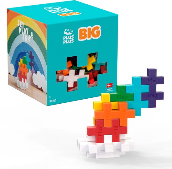 Plus-Plus BIG doos met regenboog en doorzichtige voorkant met veel kleurrijke bouwstenen. Naast de doos een regenboog bouwwerk.