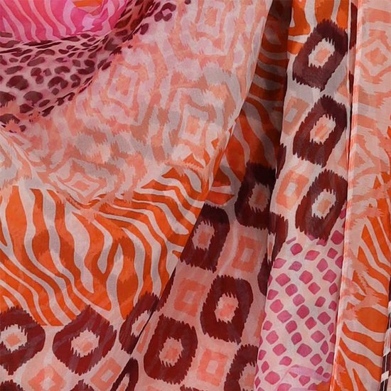 Detail van een sjaal met oranje en roze strepen, panterprint en ruitpatroon.