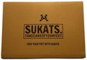 Bruine verpakking met Sukats logo en de tekst "FEED YOUR FEET WITH SUKATS".