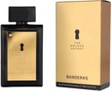 Zwarte parfumfles met goudkleurig label met sleutelgat en "THE GOLDEN SECRET" en "BANDERAS". Naast de doos met goudkleurige afwerking en hetzelfde label.