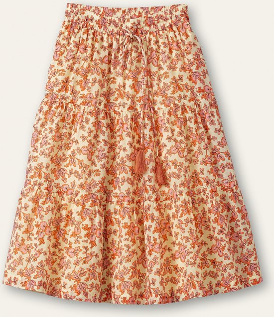 Lage taille rok met een gebloemd patroon in oranje en roze tinten op een crèmekleurige ondergrond, met ruches en decoratieve kwastjes.