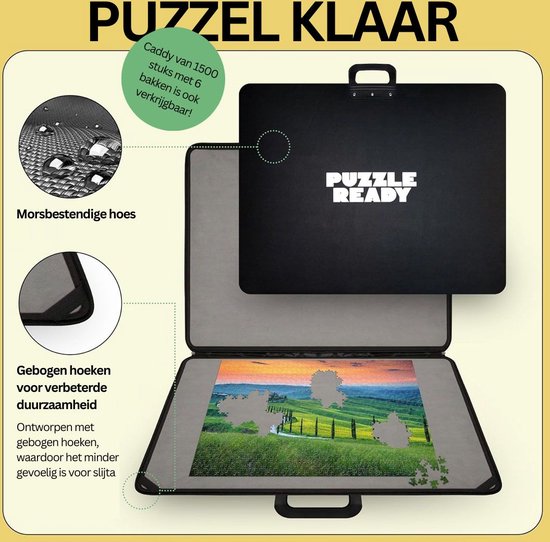 Zwarte puzzelkoffer, opengeklapt met grijze mat en landschapspuzzel. Waterdruppels op de hoes.