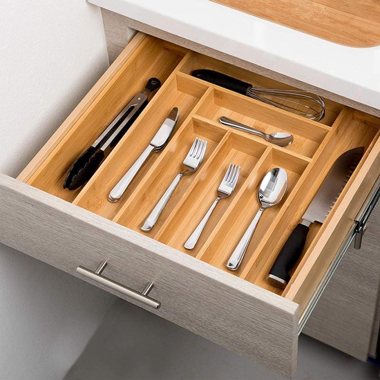Range-couverts en bambou organisé dans un tiroir, avec pinces, couteaux, fourchettes et cuillères.