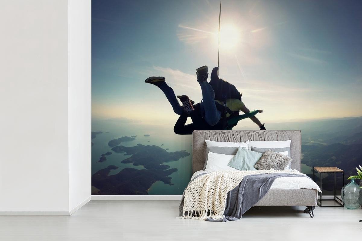 Fotobehang Sky Dive - Skydiven boven zee breedte 550 cm x hoogte 400 cm - Foto print op vinyl behang (in 7 formaten beschikbaar) - slaapkamer/woonkamer/kantoor - Nr1Wallpaper