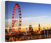 Canvas schilderij 140x90 cm - Wanddecoratie Lichtstralen langs de London Eye in Engeland - Muurdecoratie woonkamer - Slaapkamer decoratie - Kamer accessoires - Schilderijen