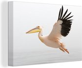 Canvas Schilderij Roze pelikaan tijdens de vlucht - 90x60 cm - Wanddecoratie