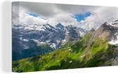 Canvas Schilderij De Zwitserse Alpen met daarop de bekende berg Schilthorn - 90x60 cm - Wanddecoratie