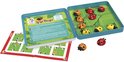 Jeu LogiBugs ouvert sur une table, montrant le plateau de jeu, des pièces détachées et le livret de règles.