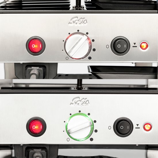 Gedetailleerd beeld van de bedieningsknoppen van de Solis grill: rode aan/uit-knop, draaiknop en zwarte aan/uit-knop.