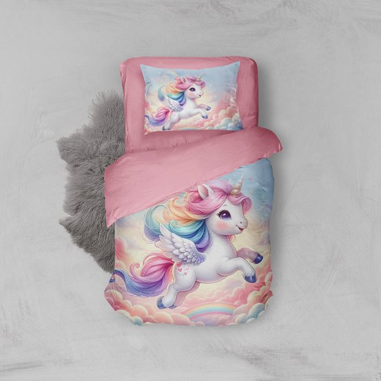 Roze dekbedovertrek en kussensloop met een eenhoorn die door wolken vliegt, pastelkleuren en regenboogmanen.