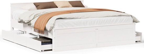 Cadre de lit blanc en pin avec tête de lit, six tiroirs et matelas fait.