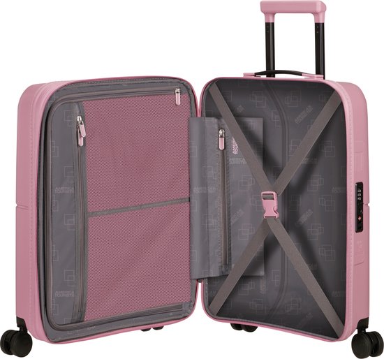 Roze American Tourister koffer, open met grijze voering, vakken en elastische banden.