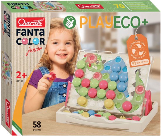 Doos van Quercetti Fanta Color Junior met een lachend meisje en het spel met een dinosaurus van groene, rode, blauwe en gele dopjes.
