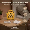Gele tijgerwekker met USB-kabel en informatie over draadloos gebruik en batterijduur.