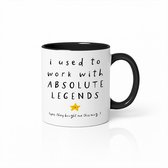Witte mok met zwarte binnenkant en handvat. Tekst: 'i used to work with ABSOLUTE LEGENDS' met een gele ster en de tekst '(yes, they bought me this mug...)'