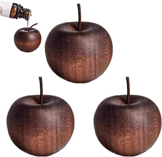 Drie bruine houten appels, één in close-up met een flesje olie dat erop druppelt.