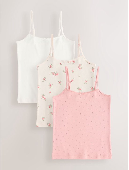Set van drie topjes: wit, crèmekleurig met rozenprint en lichtroze met kleine bloemenprint.