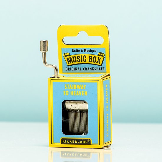 Emballage jaune de boîte à musique avec l'inscription 'Stairway to Heaven' et une manivelle argentée.