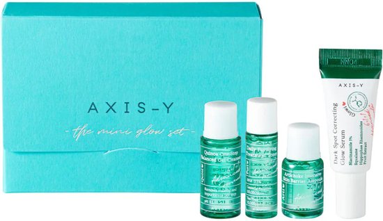 Axis-Y "Mini Glow Set" met een turquoise doos, drie miniatuurproducten en de "Dark Spot Correcting Glow Serum" tube.