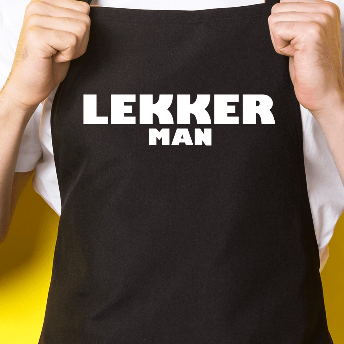 Zwart keukenschort / BBQ-schort met tekst | Lekker man | Katoen - One size - Verstelbaar - Wasbaar - Cadeau voor hem - Vaderdag - Gratis verzending - Cadeau voor Kerst & sinterklaas | Incl. 2 jaar garantie