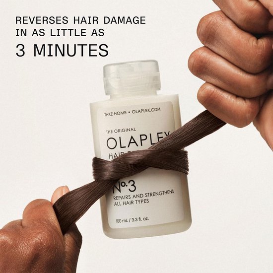 Olaplex No.3 haarverzorging gewikkeld rond een donkerbruine haarlok, met de tekst 'REVERSES HAIR DAMAGE IN AS LITTLE AS 3 MINUTES'.