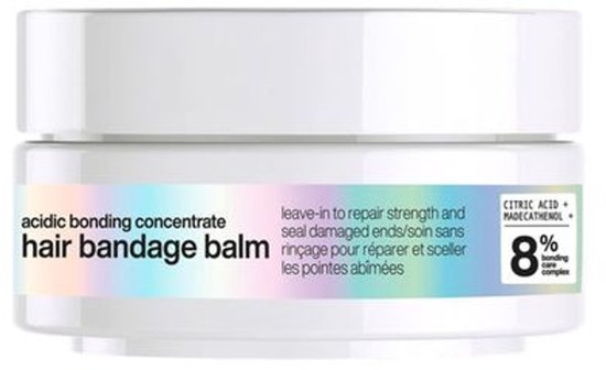 Witte pot met 'acidic bonding concentrate hair bandage balm' en een iriserende band.
