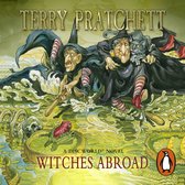Twee heksen met puntmutsen en zwart cape lopen door het water. Een heks heeft een kat op haar schouder. De titel 'WITCHES ABROAD' staat onderaan.