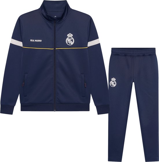 Donkerblauwe Real Madrid trainingsset bestaande uit een vest en broek, met gele bies en clublogo.