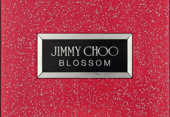 Doos Jimmy Choo Blossom met rode achtergrond en witte spikkels.