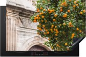 KitchenYeah® Inductie beschermer 80.2x52.2 cm - De kathedraal van Málaga met een sinaasappelboom - Kookplaataccessoires - Afdekplaat voor kookplaat - Inductiebeschermer - Inductiemat - Inductieplaat mat