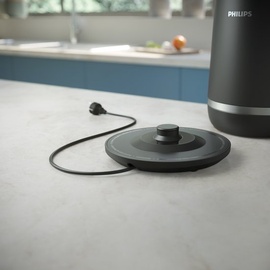 Zwarte Philips waterkoker met het netsnoer en de draadloze basis op het aanrecht.